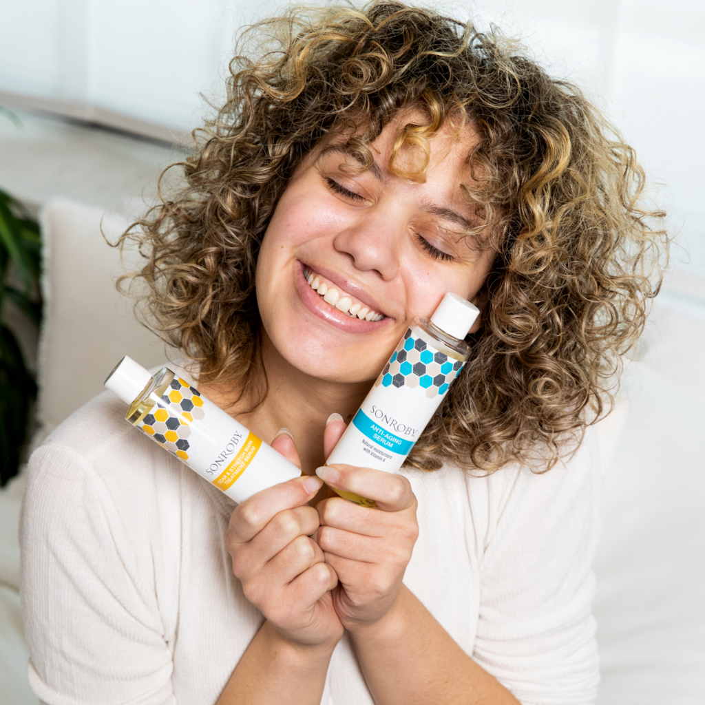 girl holding two treatment serums